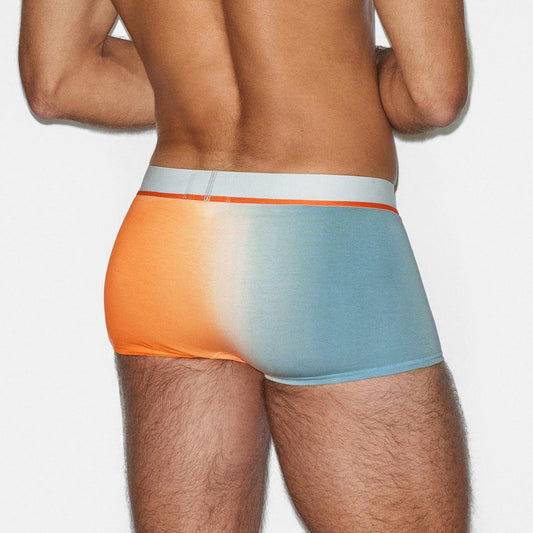Man wearing a colorful underwear with a gradient design on a plain background