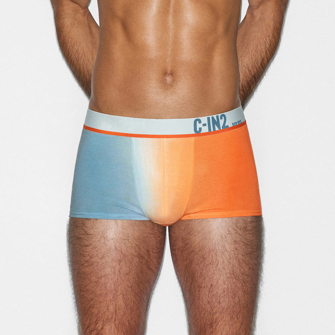 Man wearing a colorful underwear with C-IN2 branding and a gradient design on a plain background