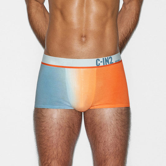 Man wearing a colorful underwear with C-IN2 branding and a gradient design on a plain background