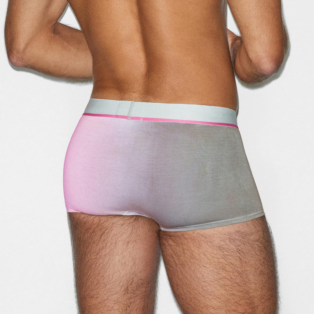 Person wearing a gray and pink underwear set on a white background
