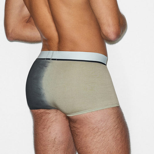 Man wearing a beige underwear with a white waistband on a plain background