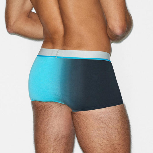 Man wearing a black and blue underwear set on a white background