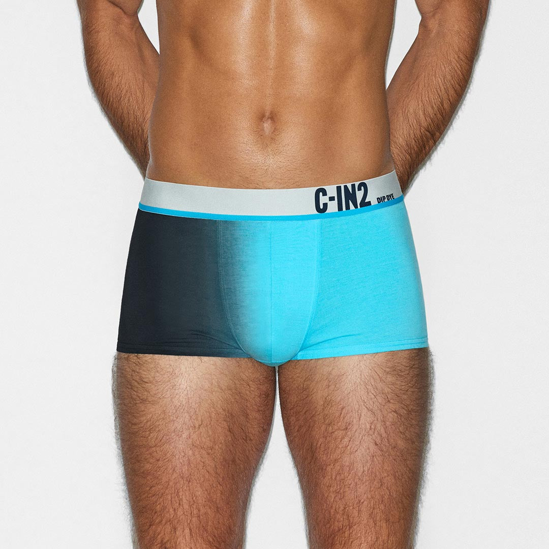 Man wearing a black and blue underwear set with a visible 'C-IN2' brand logo on a white background