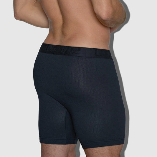 Person wearing black underwear on a plain background