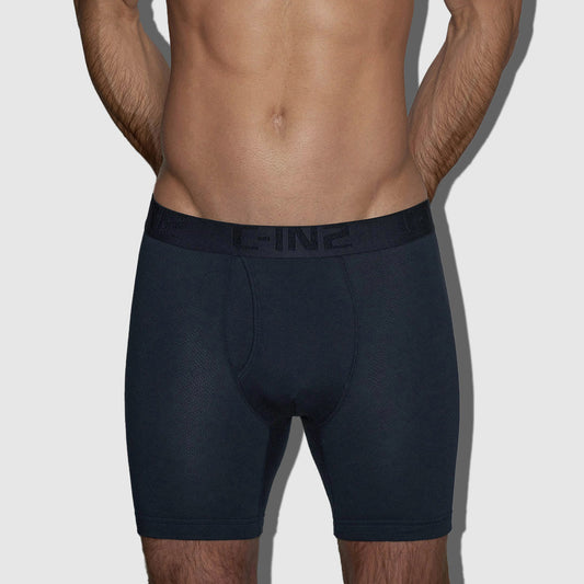 A man's lower torso wearing dark navy blue boxer briefs with a C-IN2 tonal logo on the waistband, shown against a light gray background.