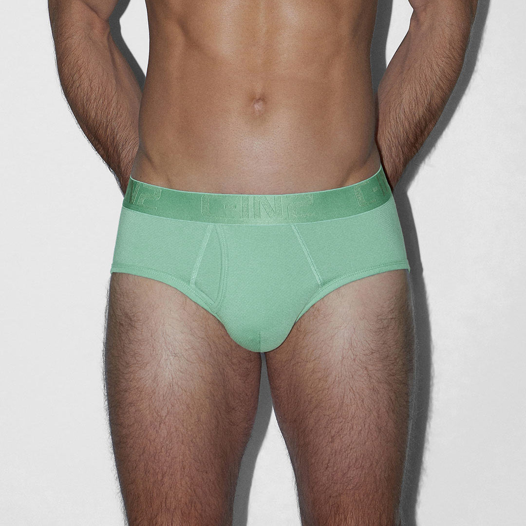 Man wearing a green underwear on a white background