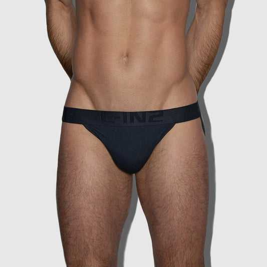 A close-up of a male model's lower torso wearing dark navy blue athletic jock with a wide elastic waistband featuring the brand name 'C-IN2' in tonal lettering.