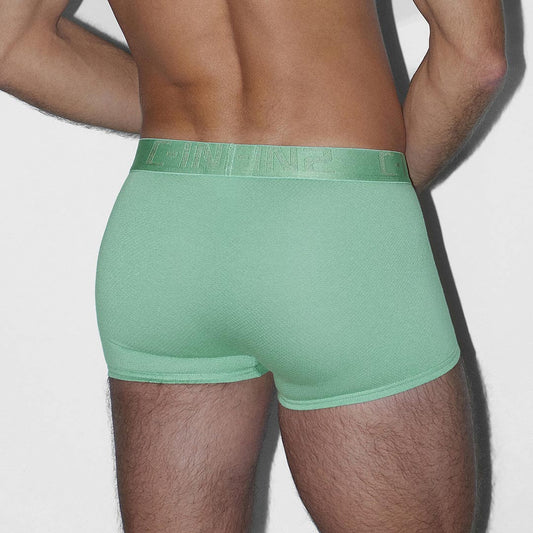 Person wearing a green underwear on a plain background