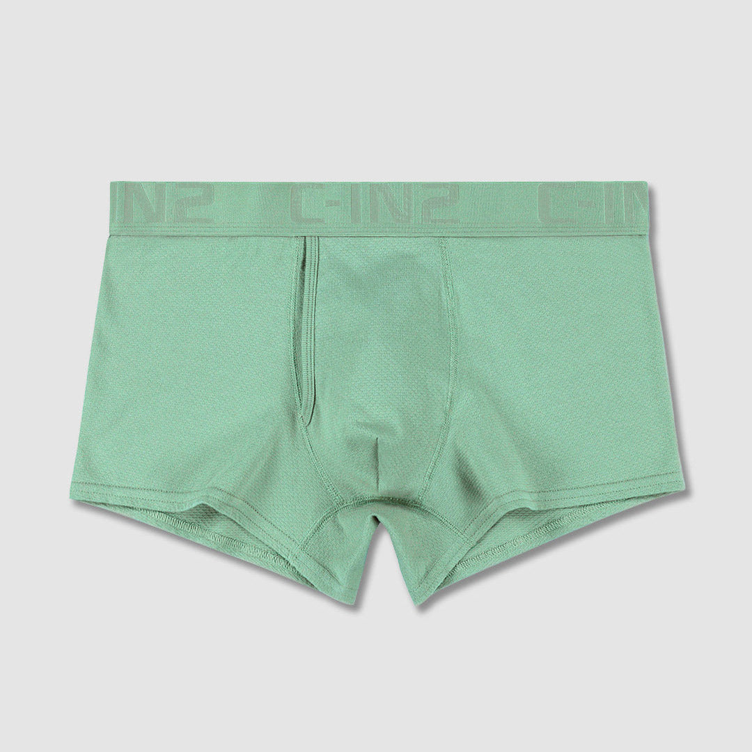 A pair of sage green boxer briefs with a matching elastic waistband featuring the brand name 'C-IN2' in tonal lettering, displayed flat against a light gray background.