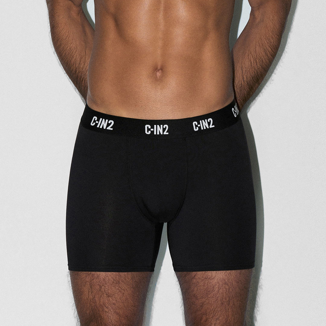 Man wearing black underwear with 'C-IN2' brand logo on a light gray background