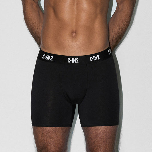 Man wearing black underwear with 'C-IN2' brand logo on a light gray background