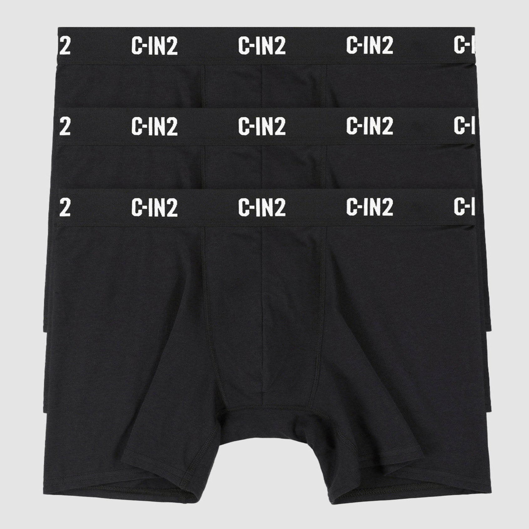 Three pairs of black boxer briefs stacked vertically, each with a white elastic waistband featuring the brand name 'C-IN2' repeated in white. The bottom pair is fully visible, while the top two are partially obscured.