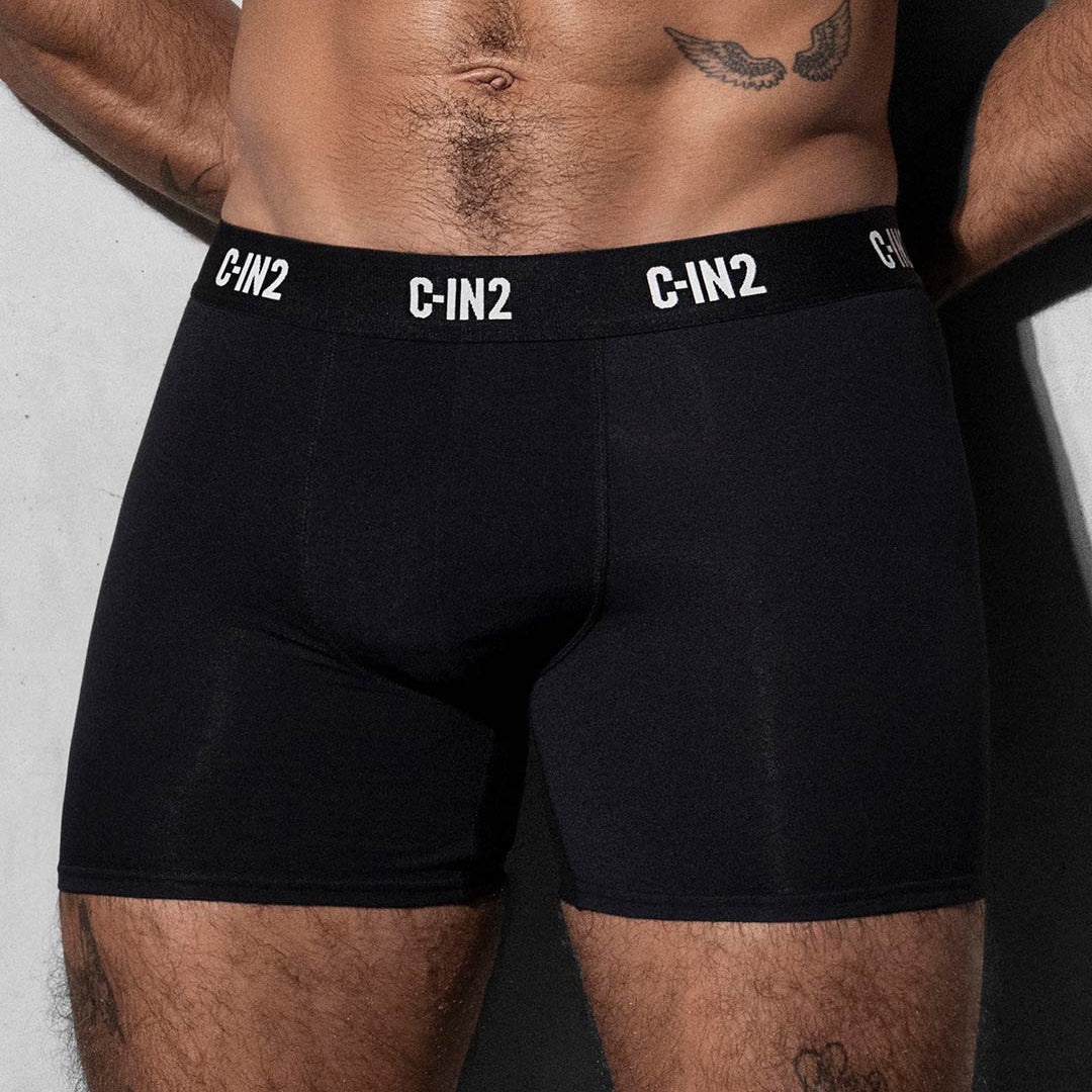 Person wearing black C-IN2 boxer briefs against a gray background