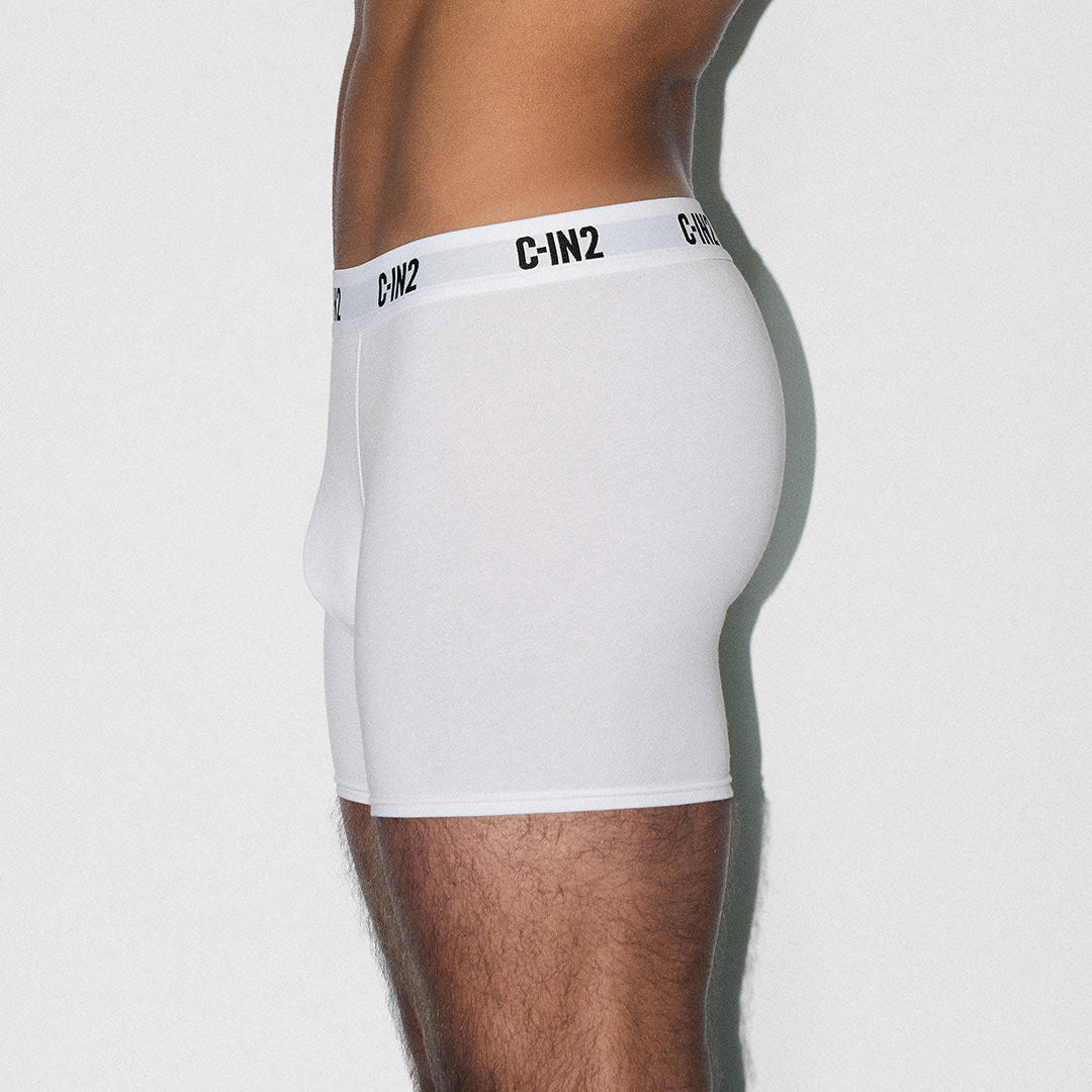 White boxer briefs with a brand logo on a plain background