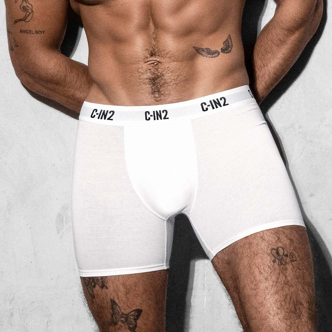 Person wearing white boxer briefs with 'C-IN2' branding on a light gray background
