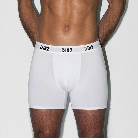 Person wearing white boxer briefs with 'C-IN2' branding on a light gray background