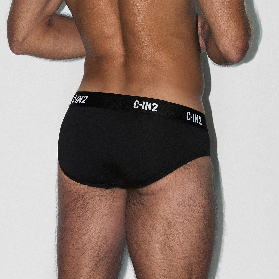 Person wearing black C-IN2 underwear on a light gray background