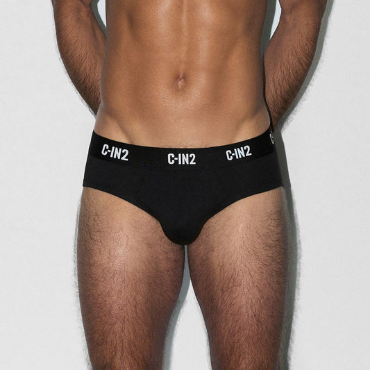 Man wearing black men's underwear with 'C-IN2' branding on a light gray background