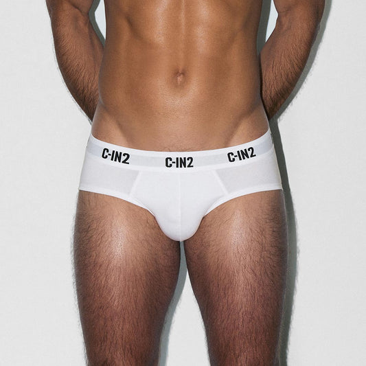 Man wearing white underwear with 'C-IN2' branding on a light gray background