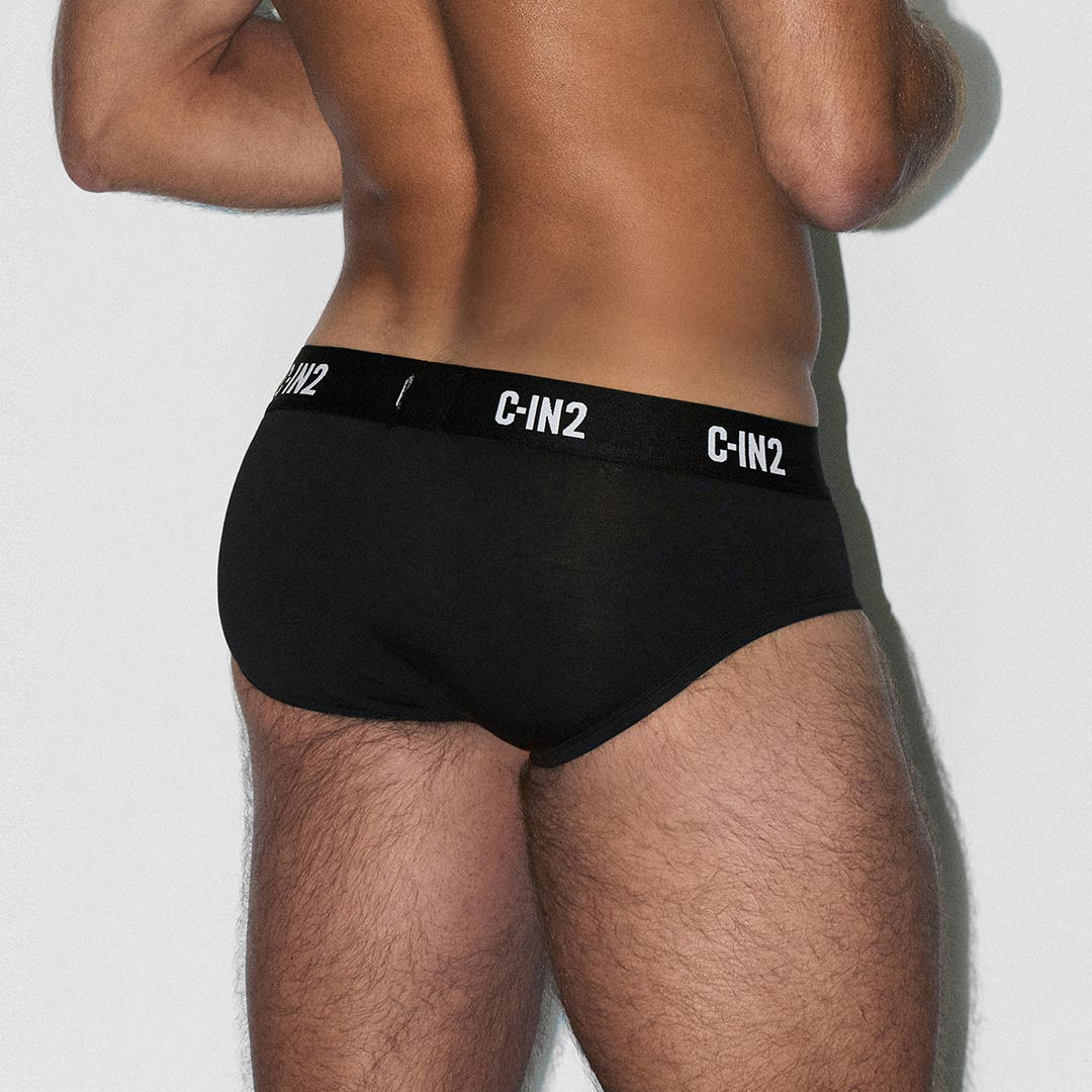 Person wearing black C-IN2 underwear on a plain background