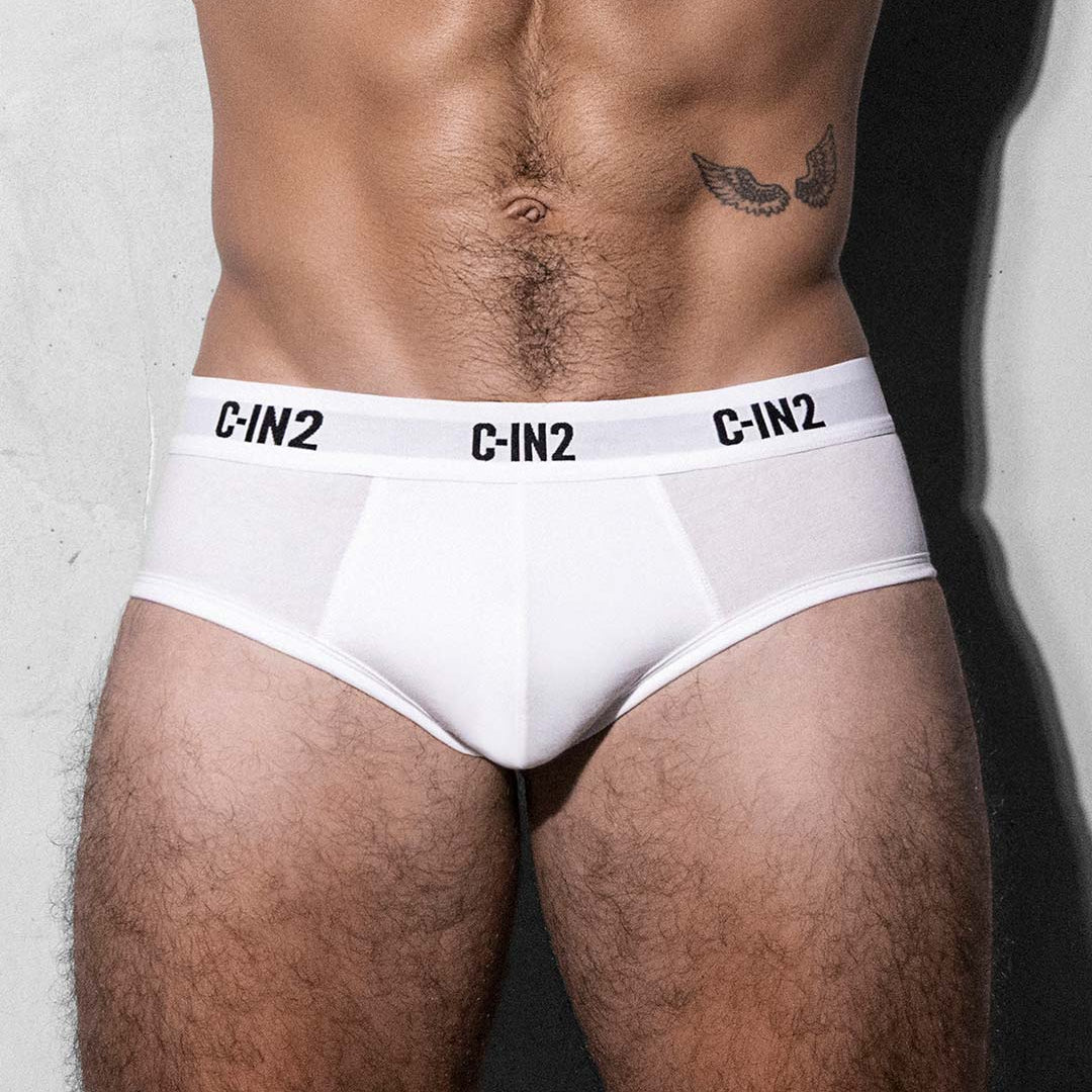 White underwear with 'C-IN2' branding worn by a person against a neutral background