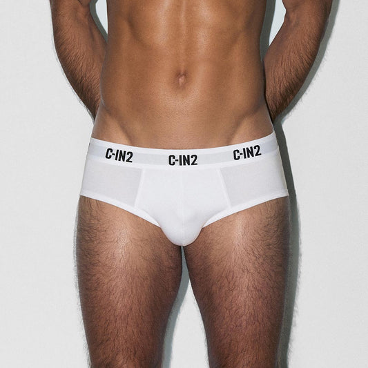 Man wearing white underwear with 'C-IN2' brand logo on a light gray background