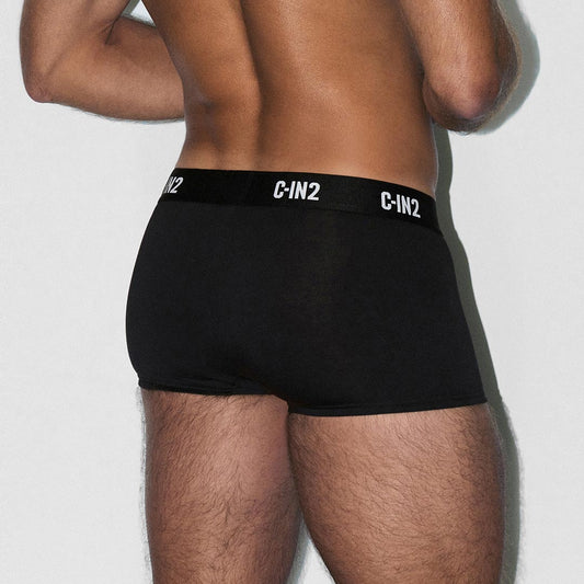 Person wearing black underwear with 'C-IN2' brand logo on a light gray background