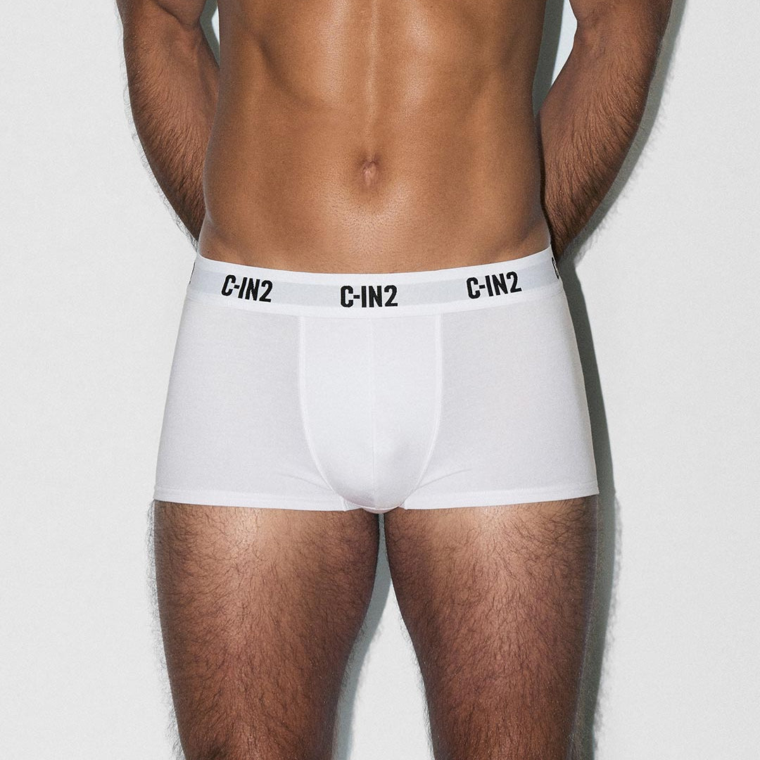 Person wearing white boxer briefs with 'C-IN2' branding on a light gray background