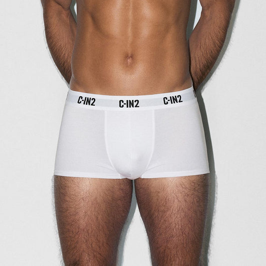 Person wearing white boxer briefs with 'C-IN2' branding on a light gray background