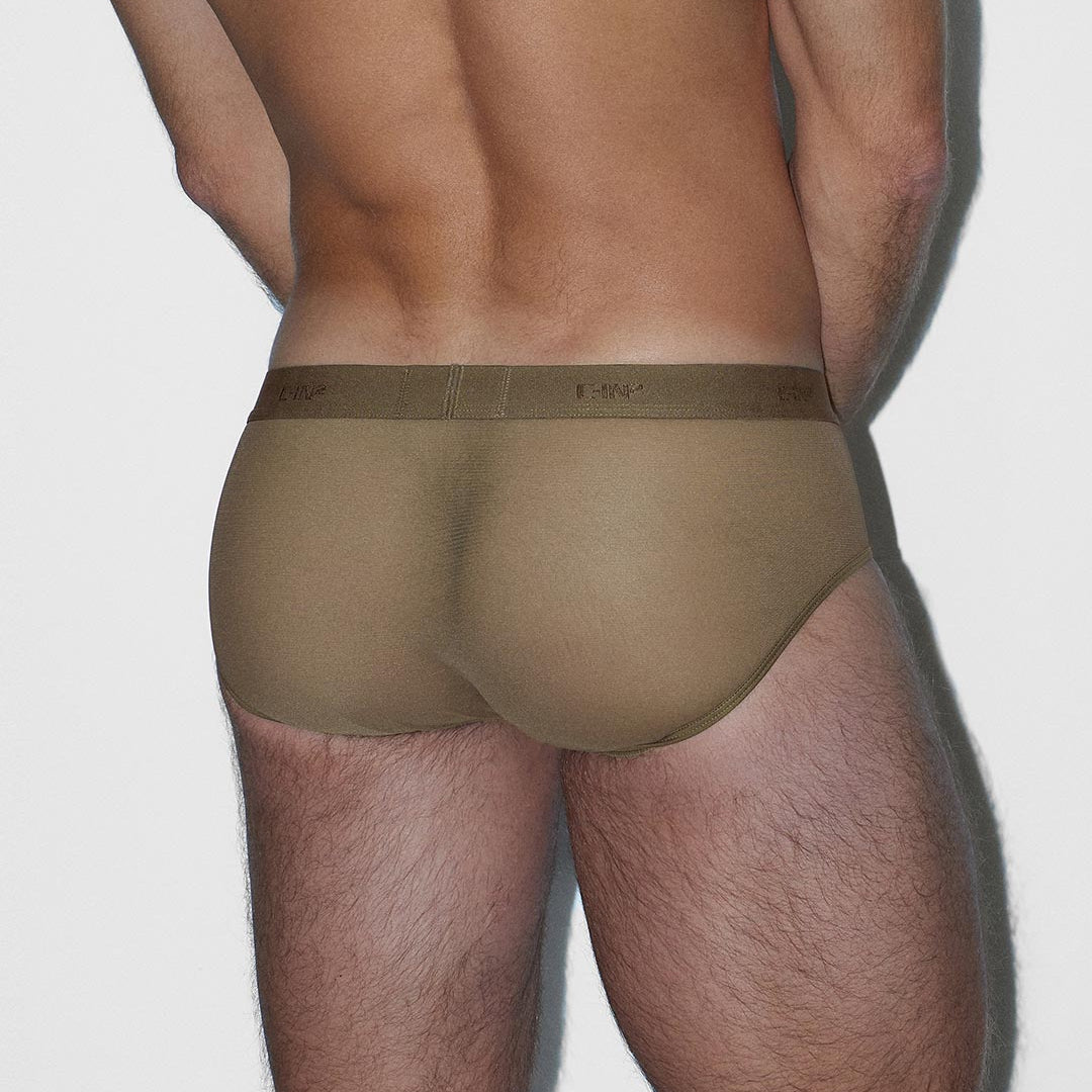 Man wearing a beige underwear on a plain background
