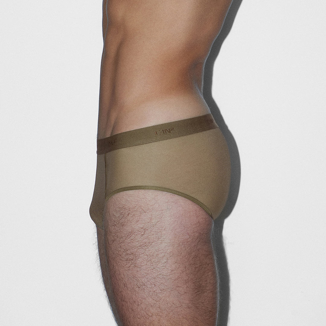 Person wearing a khaki thong on a plain background