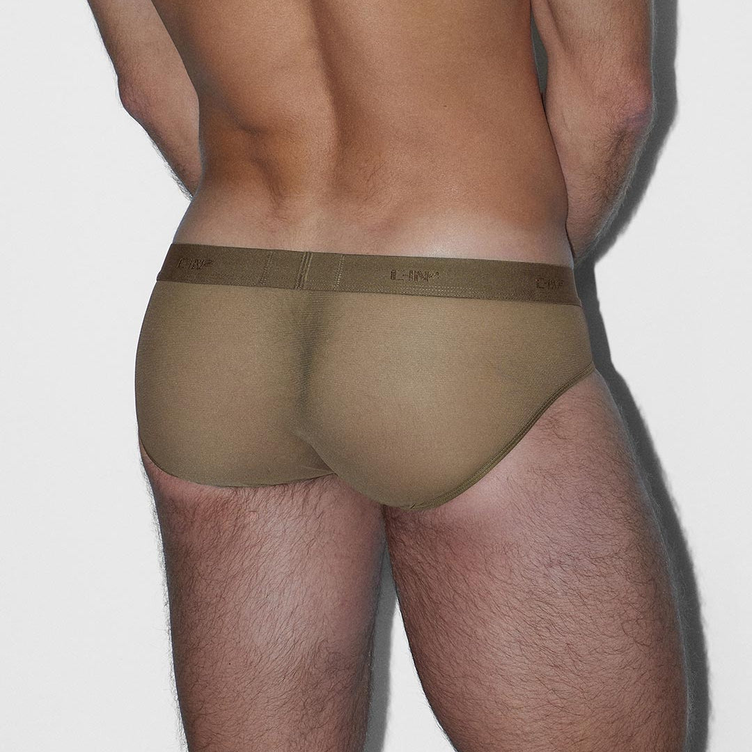 Man wearing a brown thong on a white background