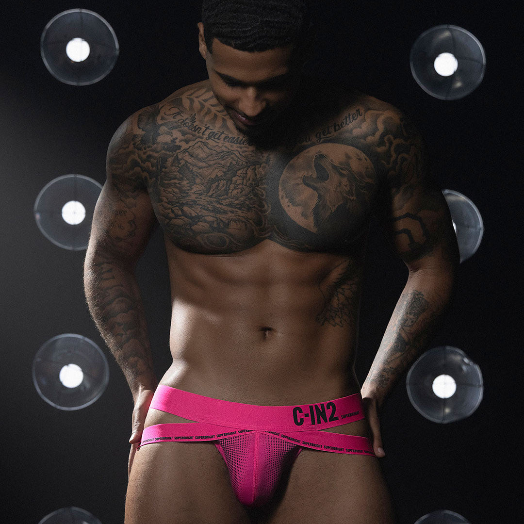Man wearing a pink men's underwear with 'C-IN2' brand on a dark background