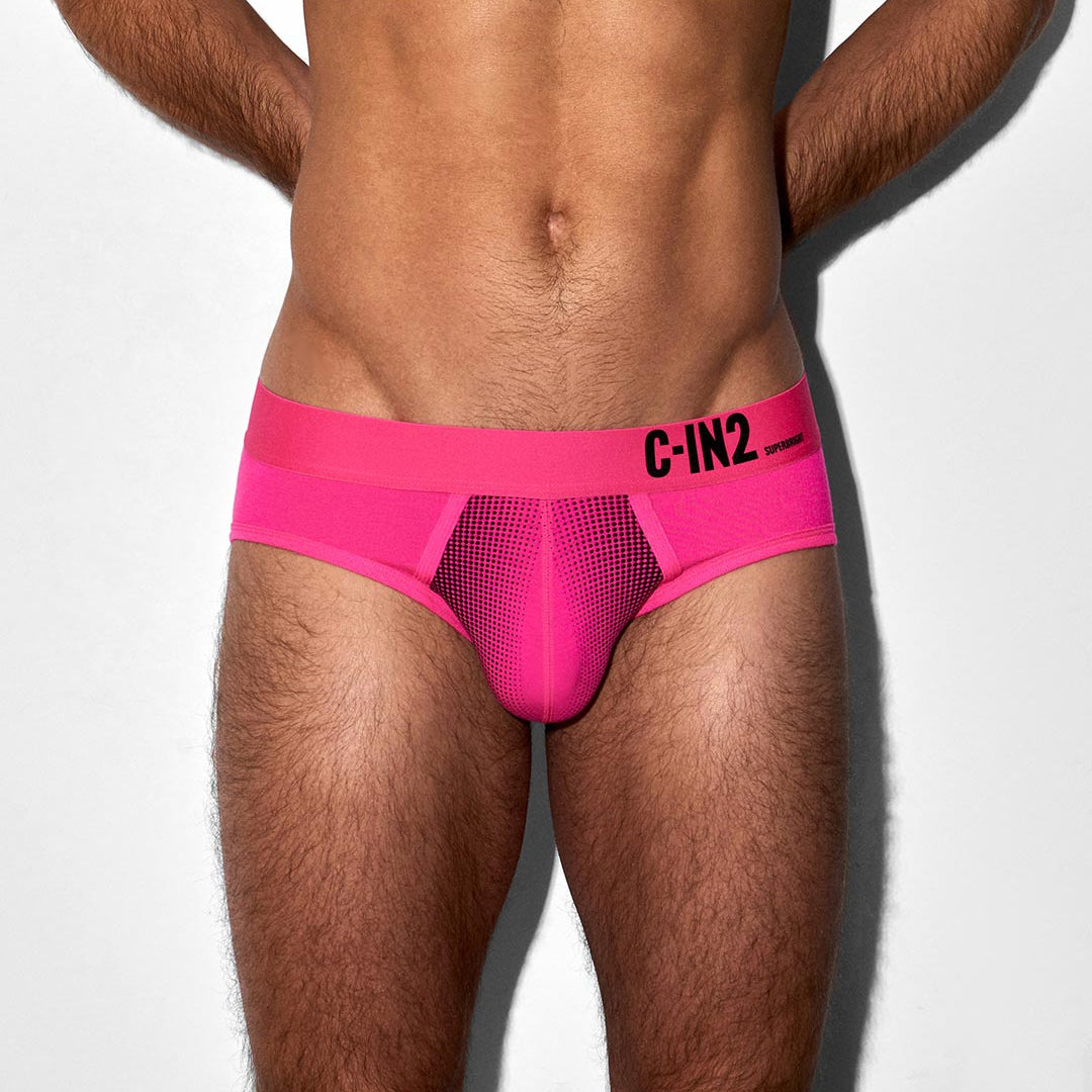 Person wearing bright pink underwear with 'C-IN2' brand logo on a white background