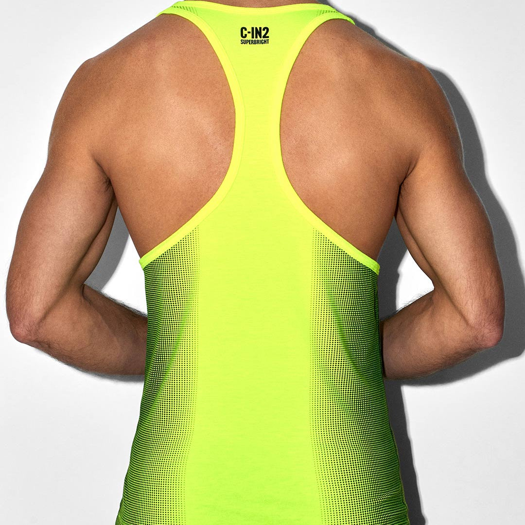 Person wearing a bright green tank top with 'C-IN2' branding on a white background