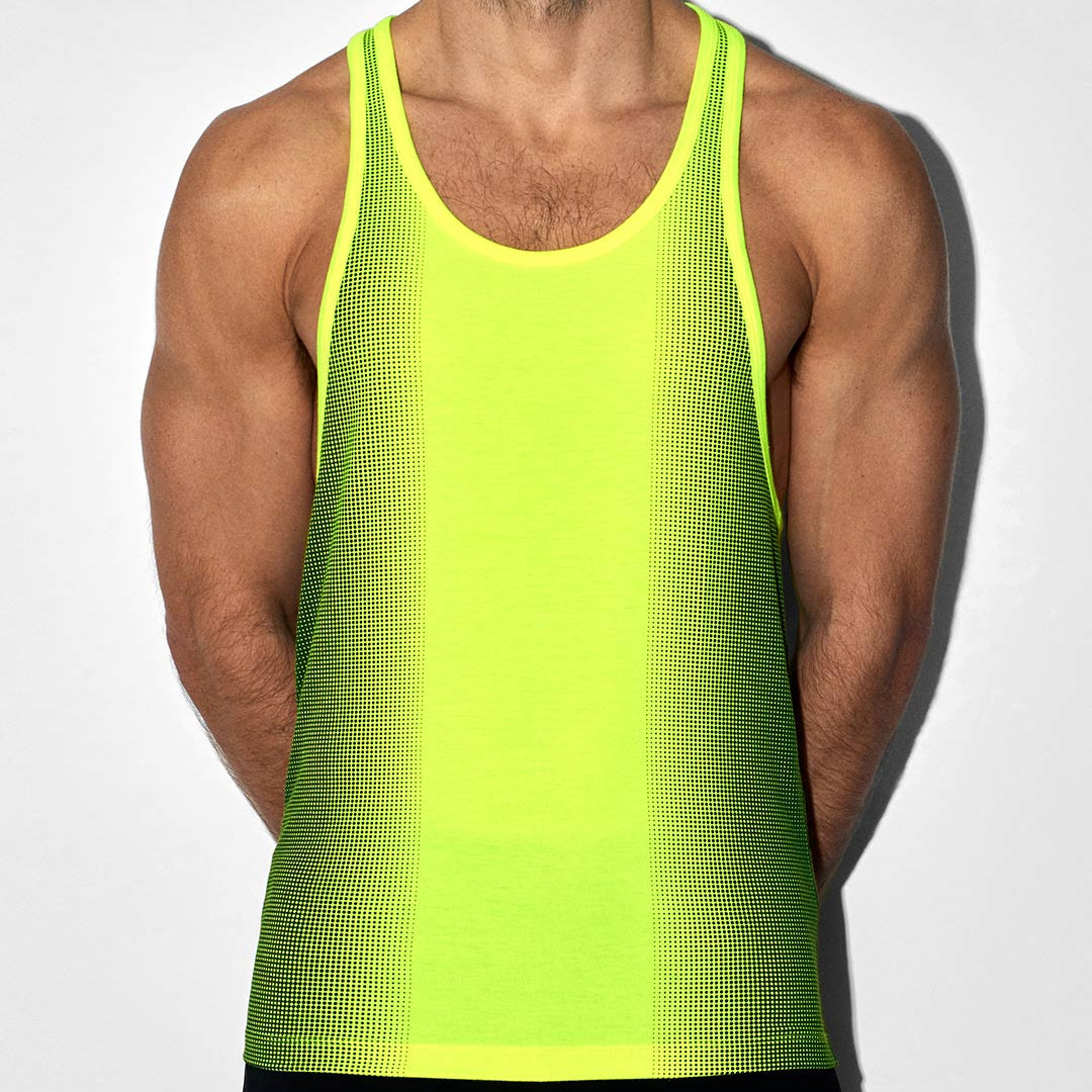 A man wearing a bright neon yellow-green athletic tank top with a subtle grid texture, shown from the waist up against a light gray background.