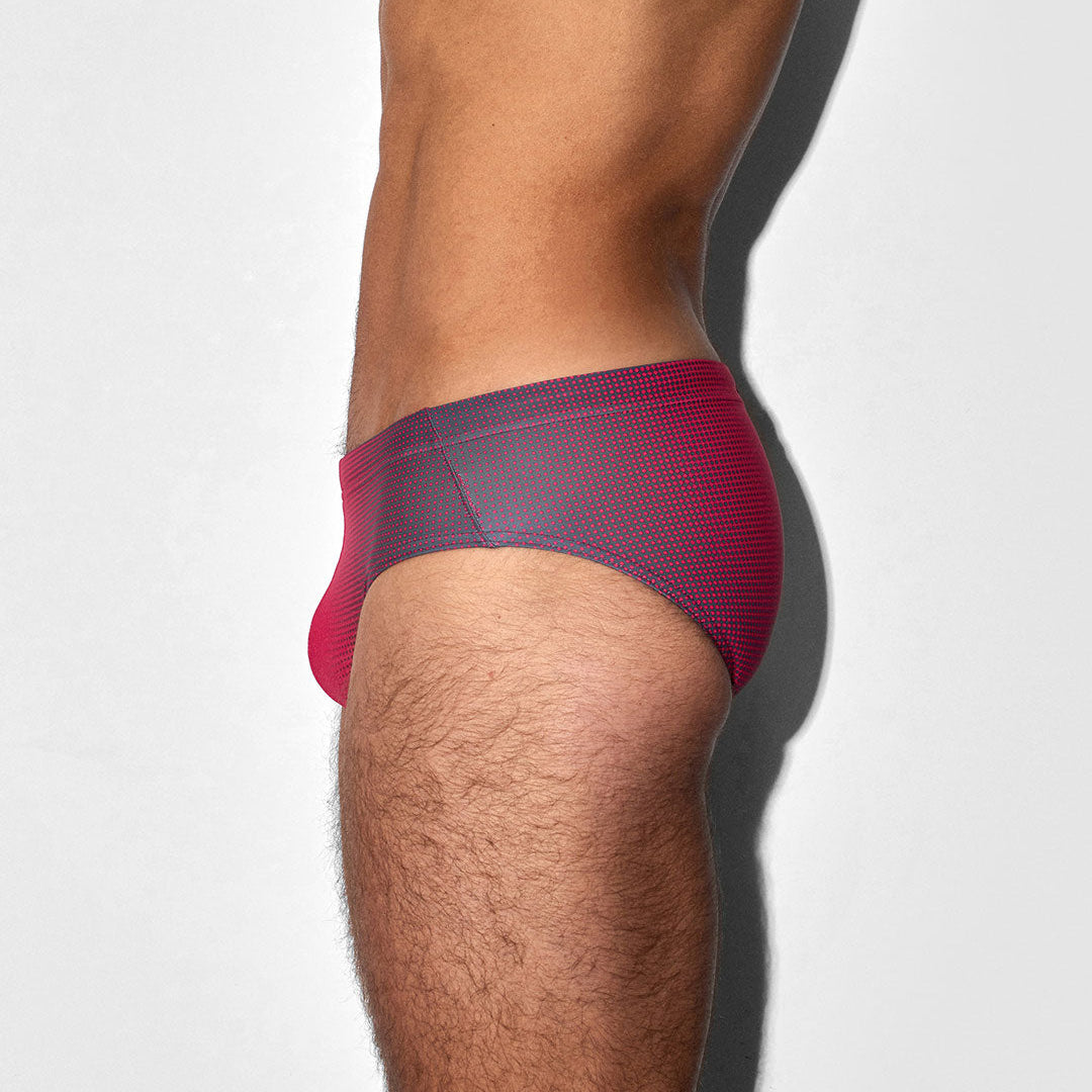 Red men's swim brief on a white background