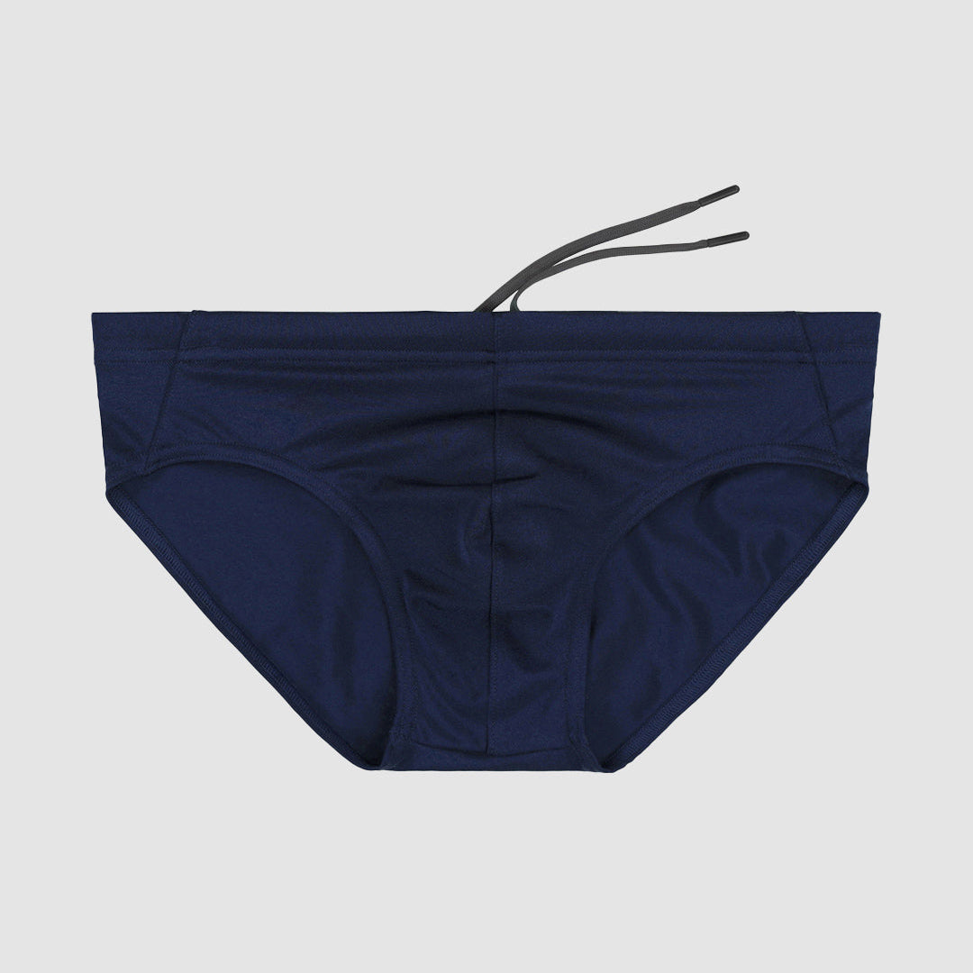 Navy blue men's bikini bottom with a string on a light gray background