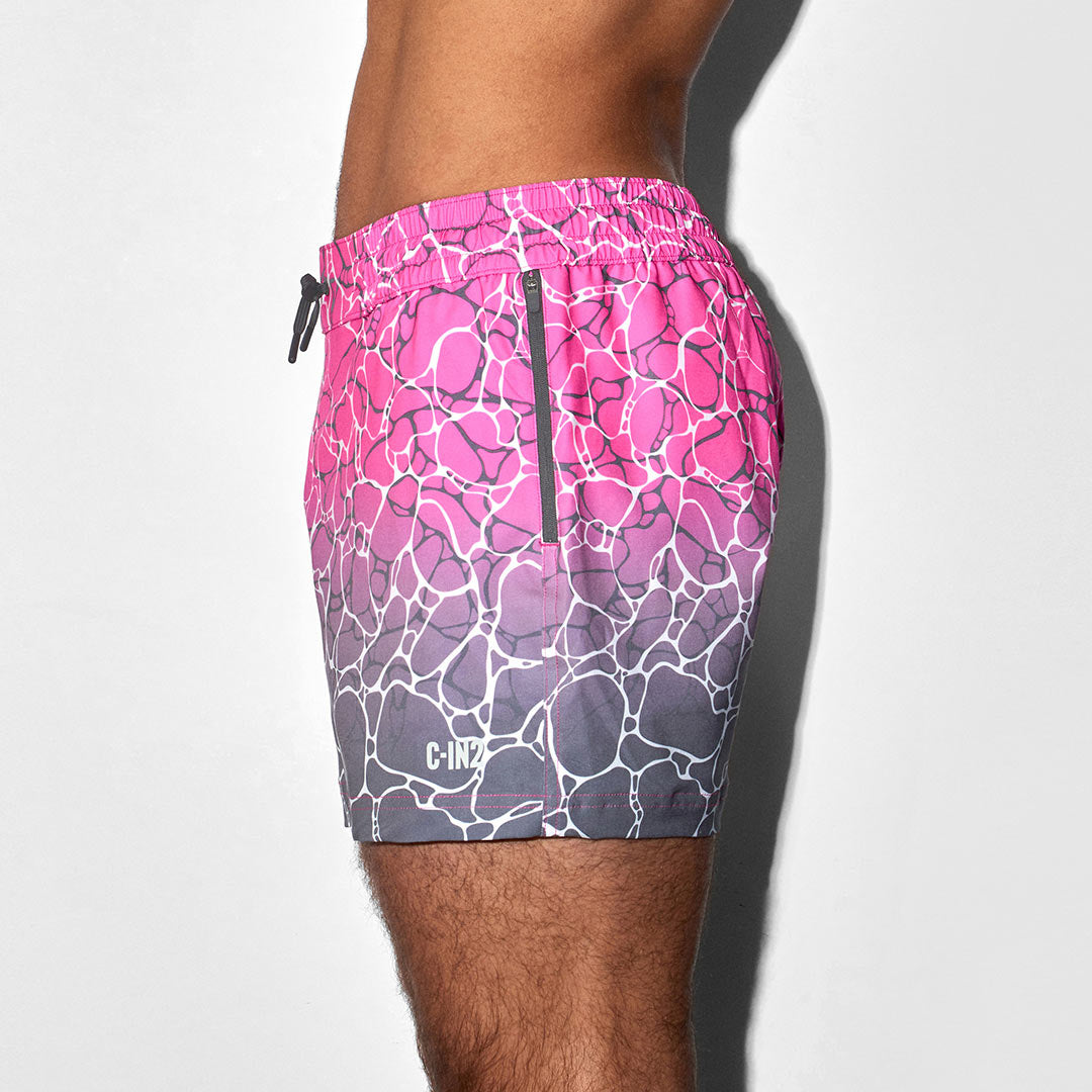 Pink and gray patterned swim shorts with C-IN2 logo on a white background