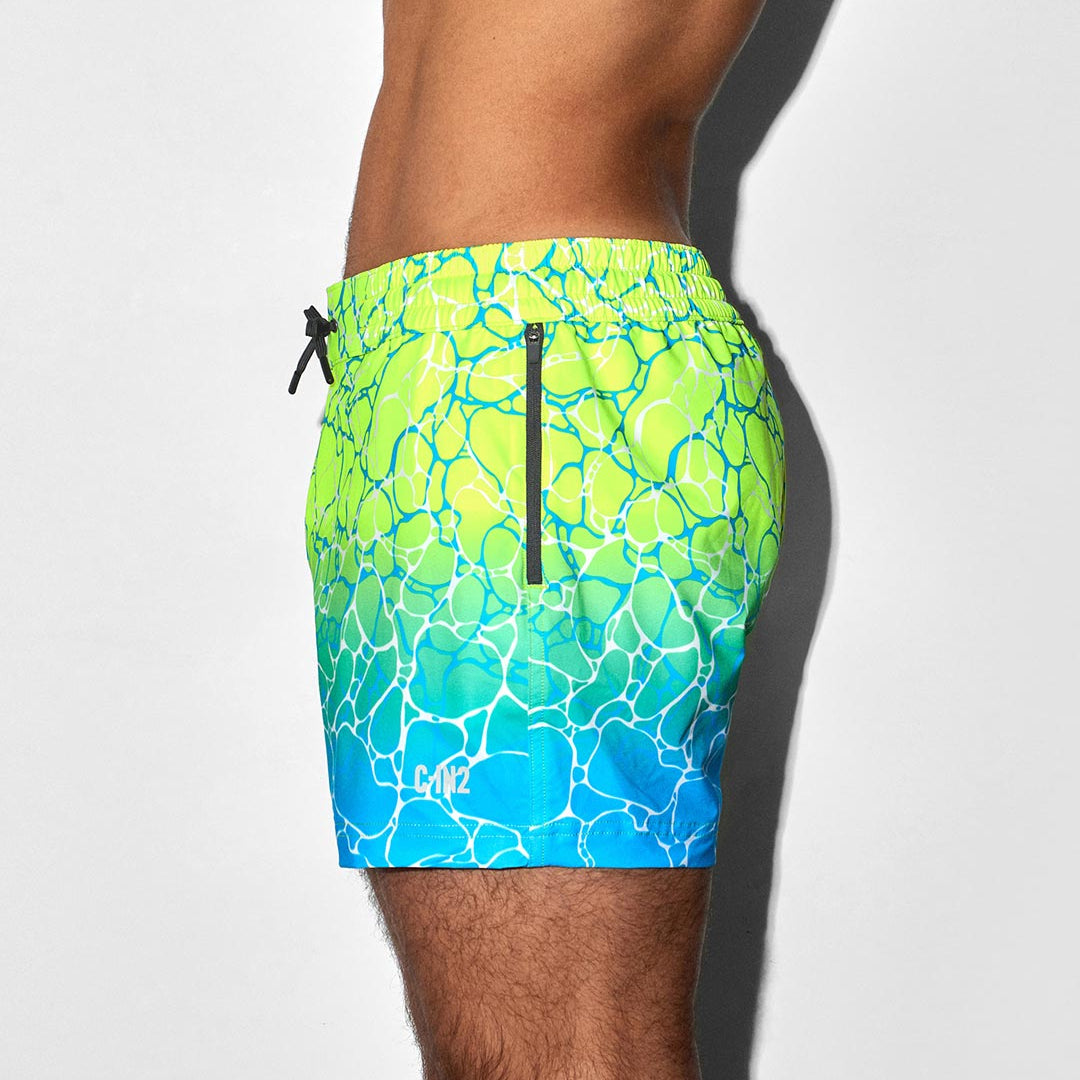 Green and blue patterned swim shorts with C-IN2 brand on a white background