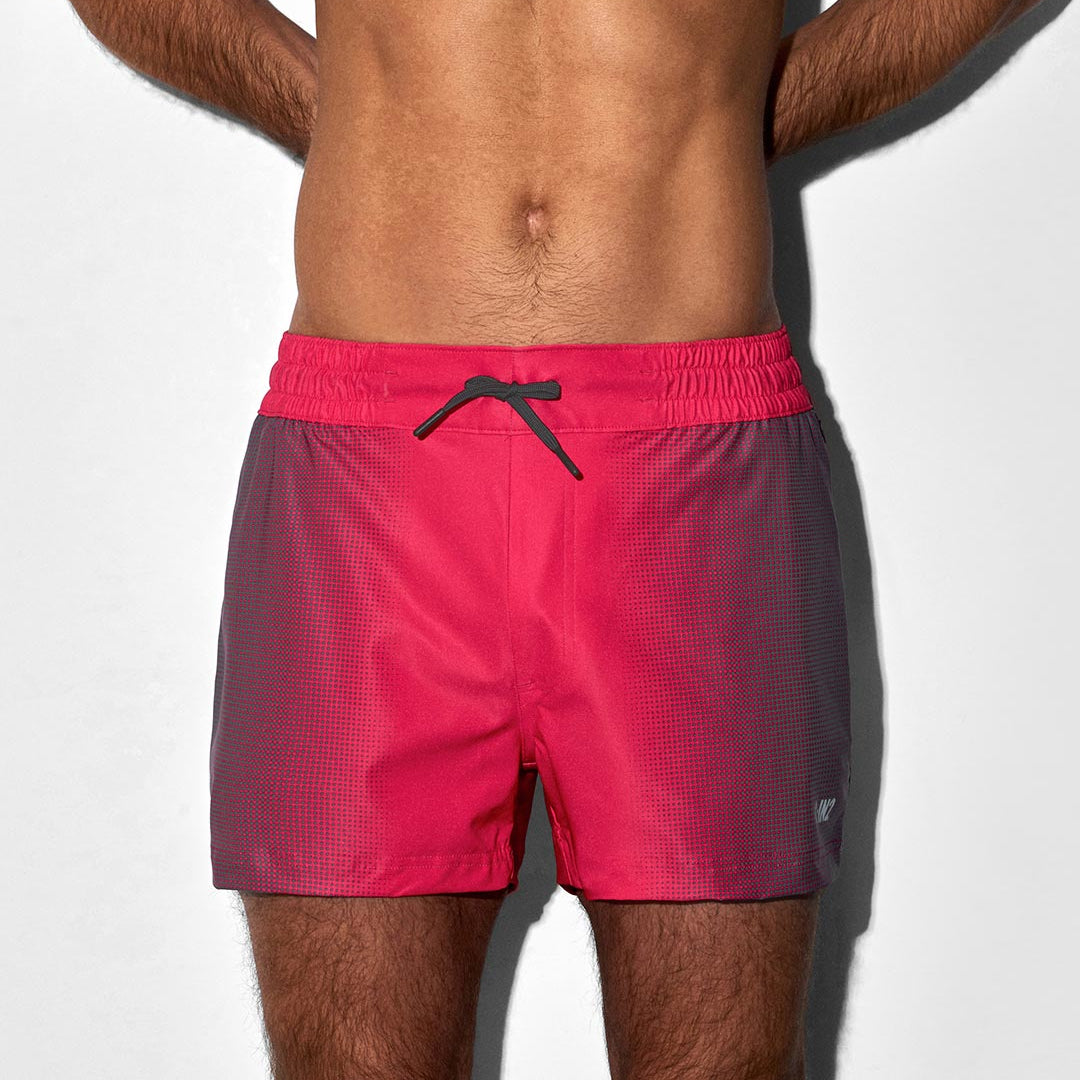 Man wearing red swim shorts on a white background