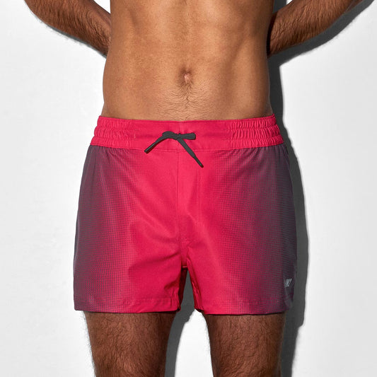 Man wearing red swim shorts on a white background