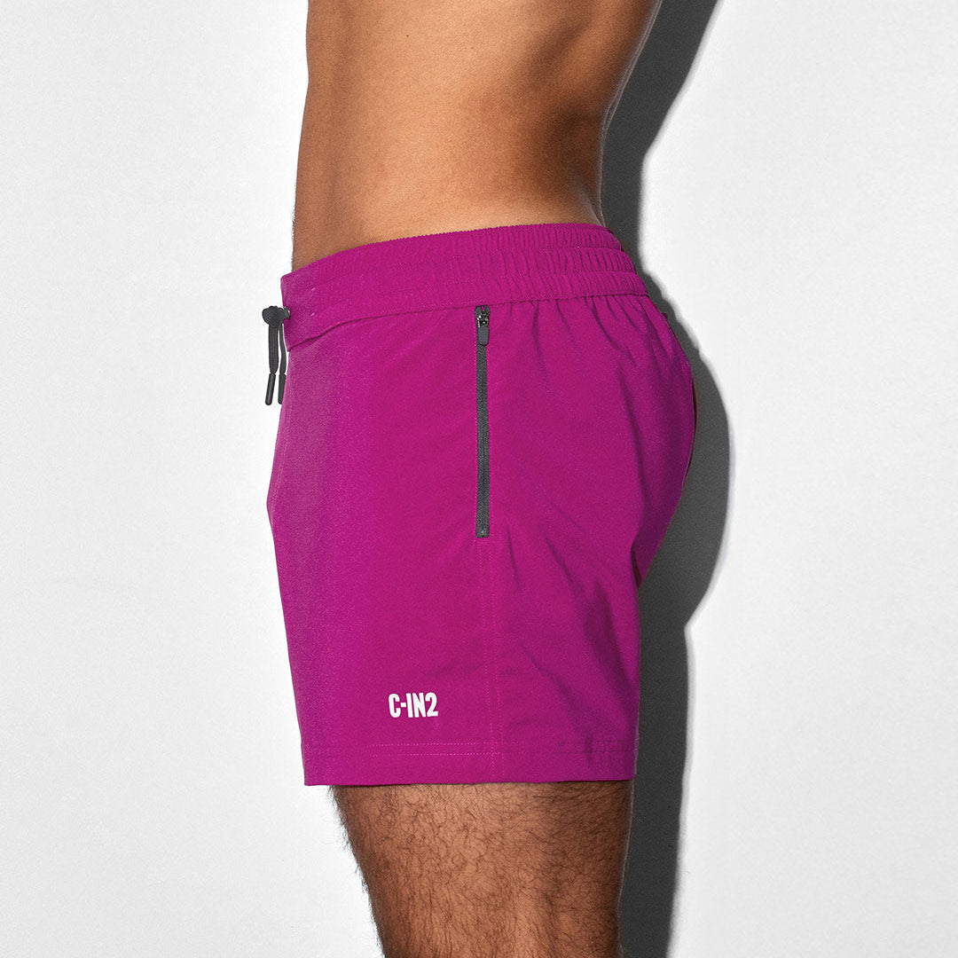 Raspberry pink swim shorts with a 'C-IN2' brand logo on a white background
