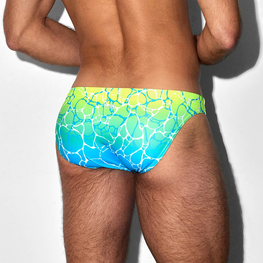 Person wearing a colorful swim suit on a plain background