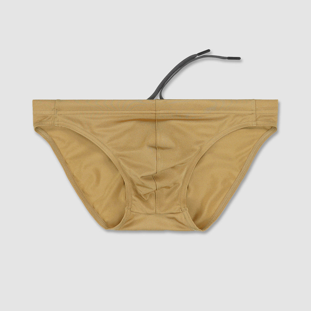 Beige bikini bottom with a black strap on a light gray background