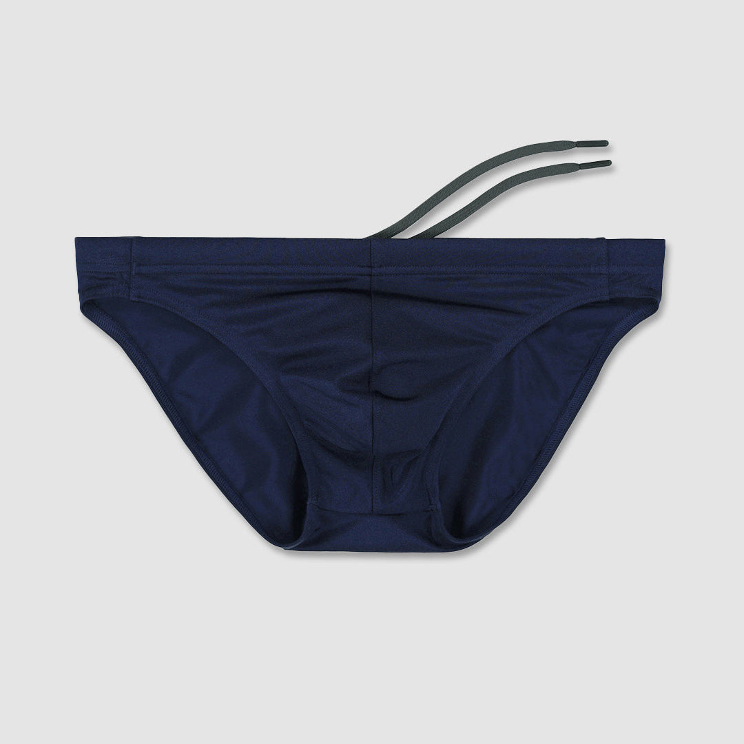 Navy blue men's bikini bottom with grey straps on a light gray background