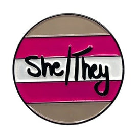 Round lapel pin with 'She/They' on a demigirl pride striped background