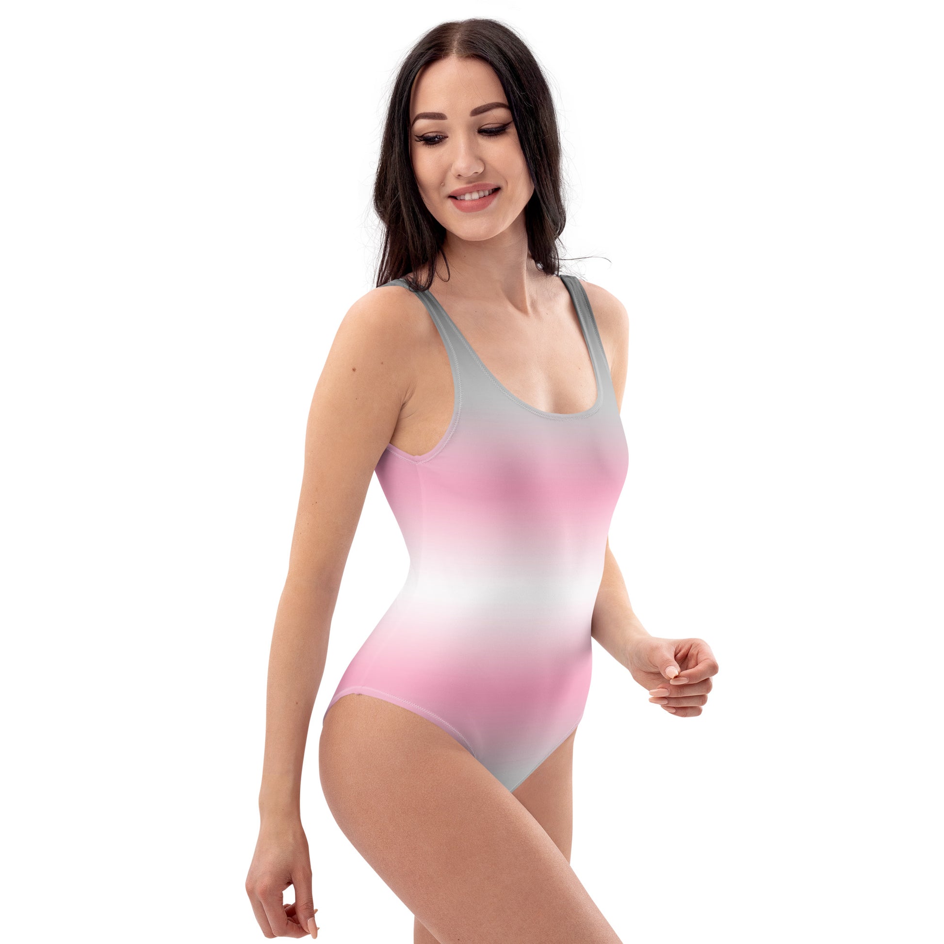 Woman wearing a gradient pink to gray swimsuit on a white background