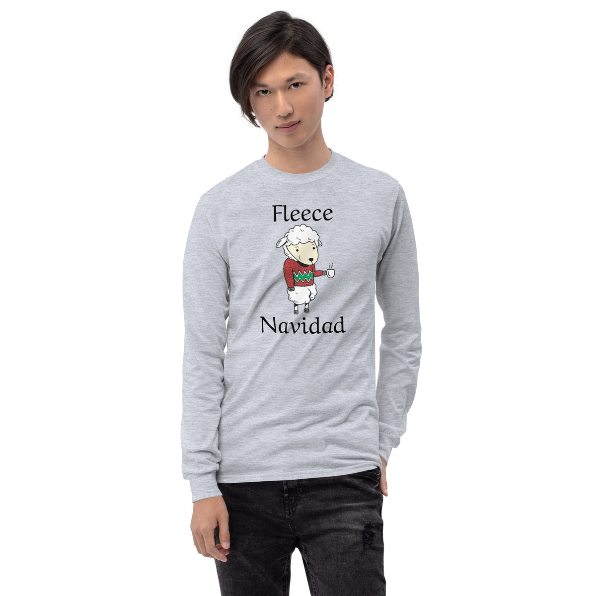 person wearing a grey long sleeve tee shirt with cute sheep wearing a holiday sweater, holding a cup of coffee and black text that reads 'Fleece Navidad'
