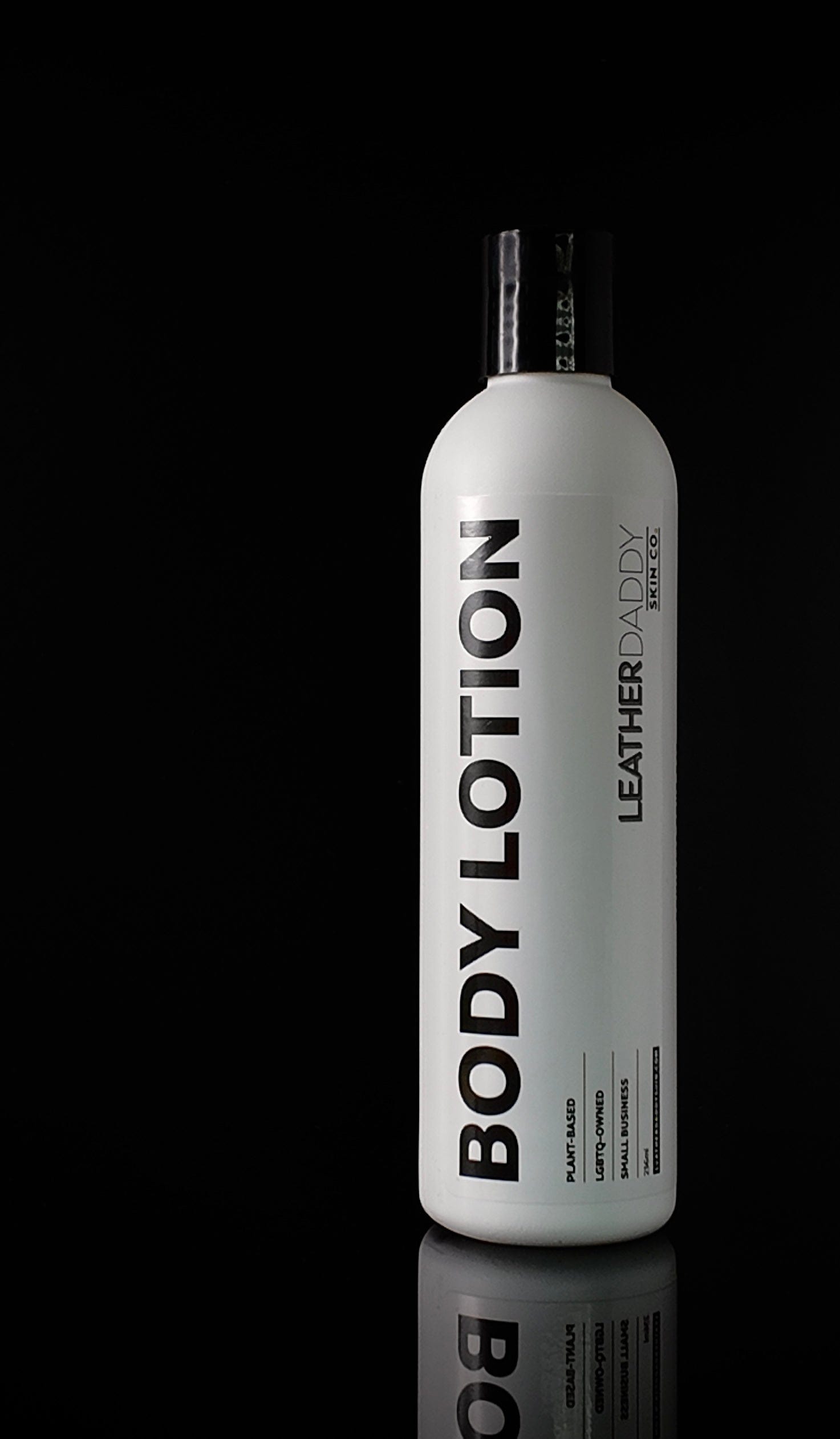 white bottle with black lettering with Body Lotion and Leather Daddy branding